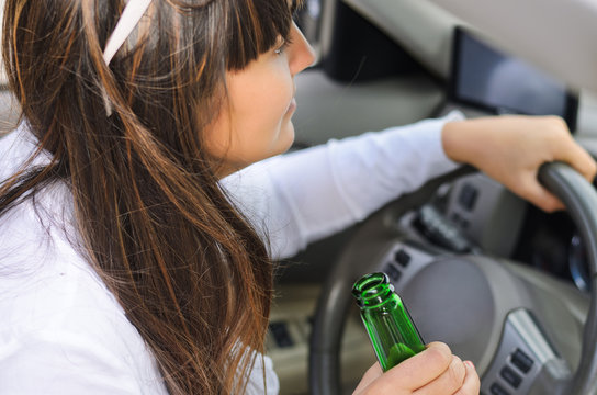 Woman drinking while driving