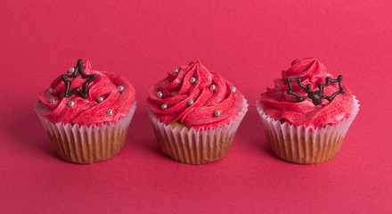 Group of Christmas cupcakes on red background