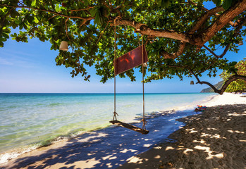 Swings at tropical beach.