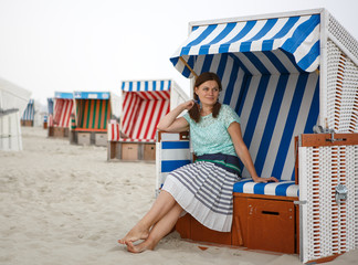 Young happy woman on the beach of St.Peter Ording, North Sea,