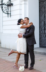Beautiful indian bride and caucasian groom after wedding