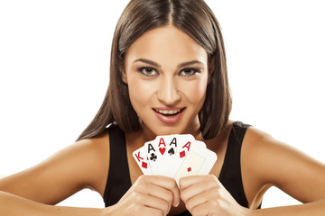 Happy girl holding the winning combination of poker cards