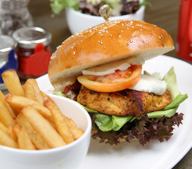 cajun chicken burger with salad and fries