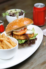 cajun chicken burger with salad and fries