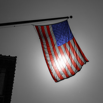 US american symbol flag over Black and white city