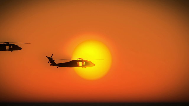 Helicopters flying in formation over sunset