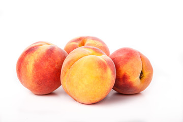 Fototapeta na wymiar Four Peaches on White