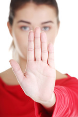 Confident woman making stop gesture sing