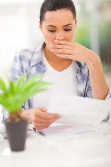 young woman got shocked when receive monthly statement