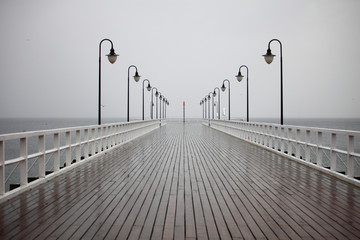old pier in rain on Baltic sea Orlowo Gdynia Poland - obrazy, fototapety, plakaty