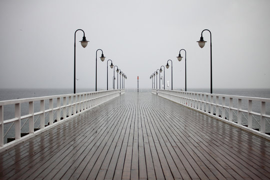 old pier in rain on Baltic sea Orlowo Gdynia Poland