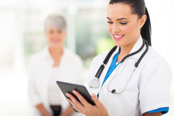 female healthcare worker using tablet computer in hospital