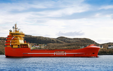 Red and yellow Norwegian platform supply ship