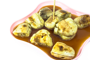 Banana toast with syrup isolated on white background