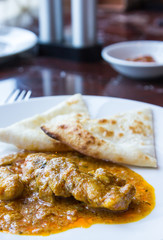 Flat bread with chicken massaman curry sauce