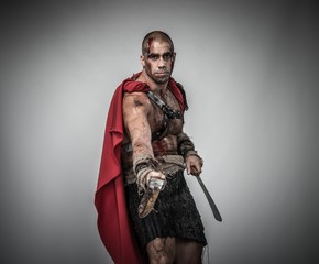 Wounded gladiator with sword covered in blood