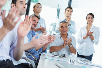 Fototapeta na wymiar Business people clapping in a meeting