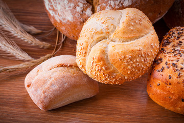 Assortment of fresh bread on wooden table