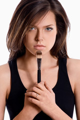 Obraz premium Portrait of beautiful woman applying cosmetic. Make-up