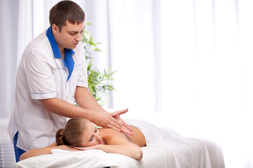 Obraz na płótnie Canvas Masseur is massaging female