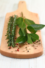 Branch of laurel bay leaves, rosemary and colorful pepper