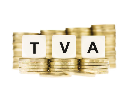 TVA (Value Added Tax) on Piles of Gold Coins with a White Backgr