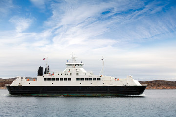 White passenger ferry goes on fjord in Norway