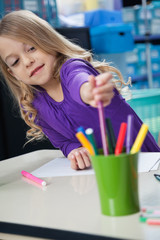 Girl Picking Sketch Pen From Case In Classroom