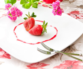 Fresh strawberries  as romantic dessert  on a plate in heart sha