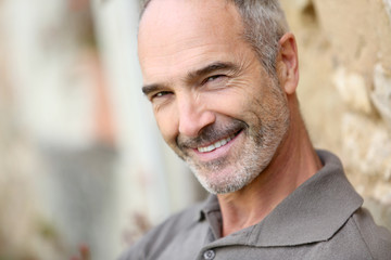 Fototapeta premium Portrait of smiling handsome mature man