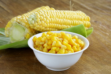 Canned corn in a bowl, and fresh cobs © Olga Kriger