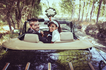 Just married couple in an old car