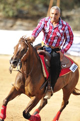Fototapeta premium Man is riding a horse
