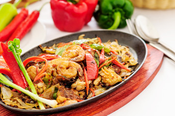 Spicy fried seafood on a hot pan.