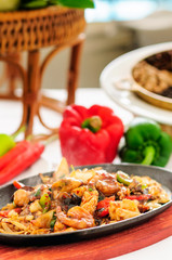Spicy fried seafood on a hot pan.