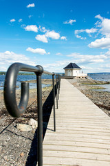 Lone standing house and pathway on fjord