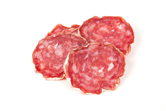 pile of red salami, on a white