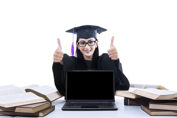 Graduate woman giving thumbs up - isolated