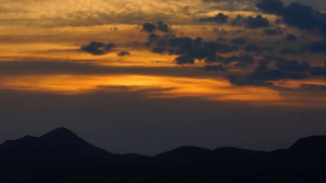 Sunset over mountains - timlapse HD video