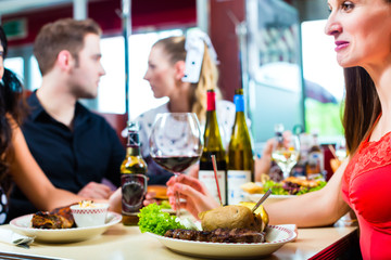 Friends eating and drinking in fast food diner