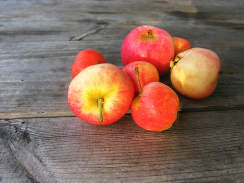 Red apples on a wooden surface