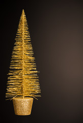 christmas golden tree on dark brown