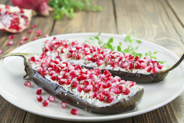 Baked eggplant with cheese, pomegranate and cumin