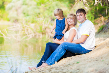 Fototapeta premium happy young family spending time outdoor on a lake
