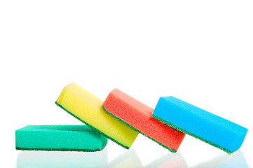Four multi-colored sponges on white background