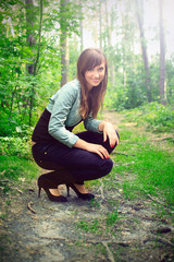 beautiful brunette on a forest road