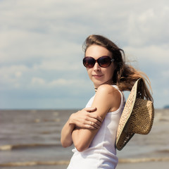 Sexy girl in sunglasses on beach.