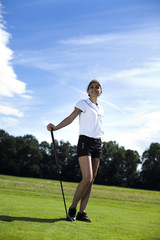 Woman playing golf on field 