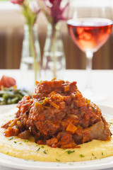 braised veal also called osso buco on polenta with wine
