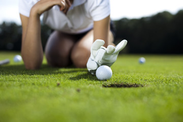 Woman playing golf on field 